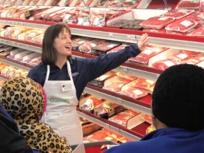 Grocery store employee helping family