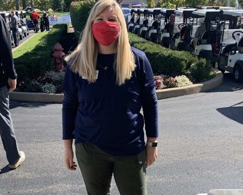 An OFS staff member takes a break in front of the golf carts.