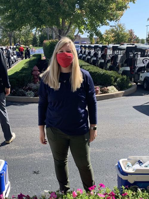 An OFS staff member takes a break in front of the golf carts.