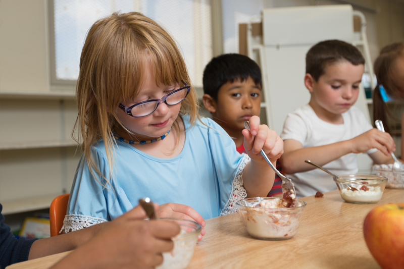 Children enjoying a bowl of yogurt