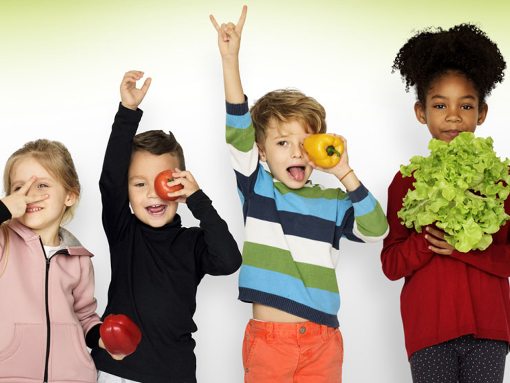 Children posing with vegetables