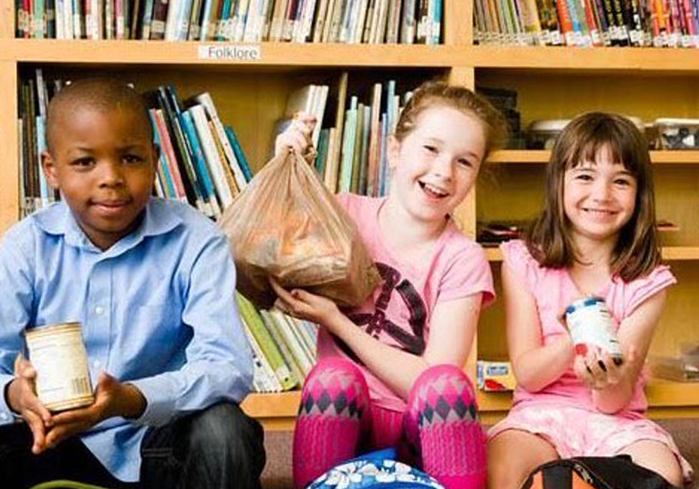Group of young volunteers donating food at a local library