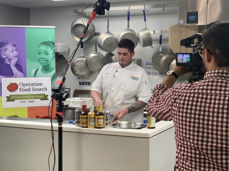 Chef prepares a meal in front of a video camera