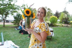 Guest with sunflowers at Feast for Change event