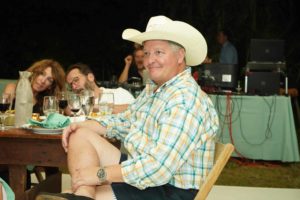 Seated guest in cowboy hat at Feast for Change event