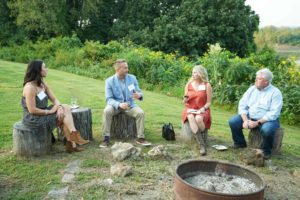Chatting guests seated on stumps at Feast for Change Event