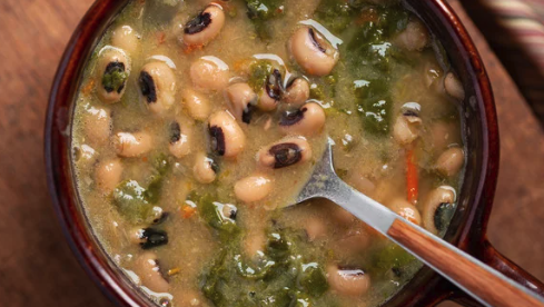 bowl of black eyed pea soup with collard greens